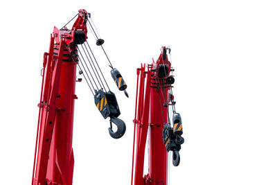 Construction crane for heavy lifting isolated on white. construction industry. red crane with hook.