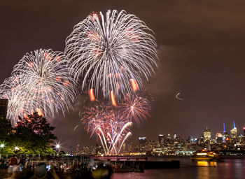 Low angle view of firework display at night