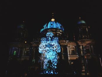 Low angle view of illuminated cathedral against sky at night