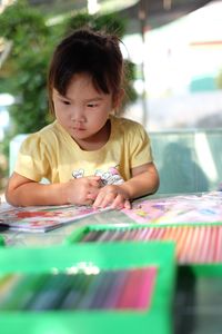 Cute girl sitting on table