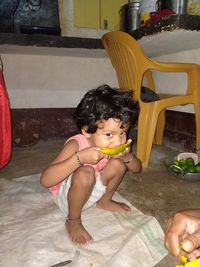 Cute girl sitting on sofa at home