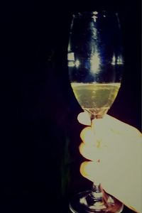 Close-up of wine glass against black background