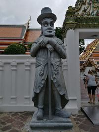 Statue in front of building