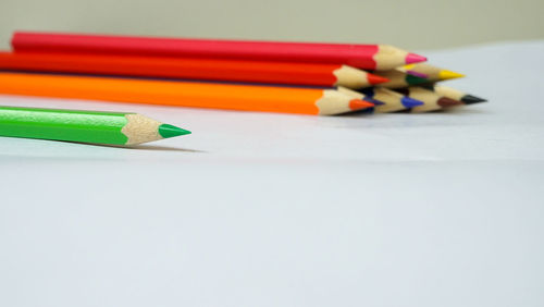 Close-up of multi colored pencils on table