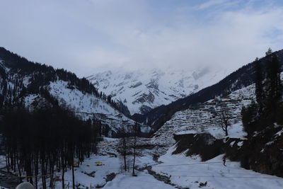 Scenic view of snowcapped mountains against clear blue sky