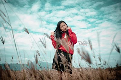 Young woman looking away while standing on land