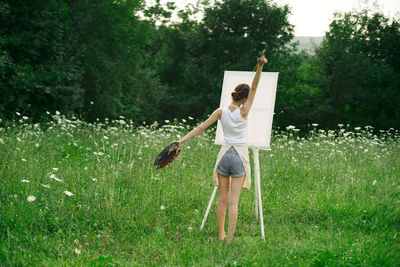 Full length of woman standing on field