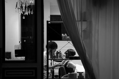 People sitting in restaurant seen through glass window