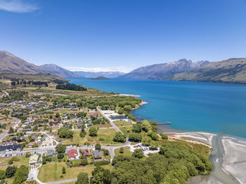 High angle view of townscape by sea against sky