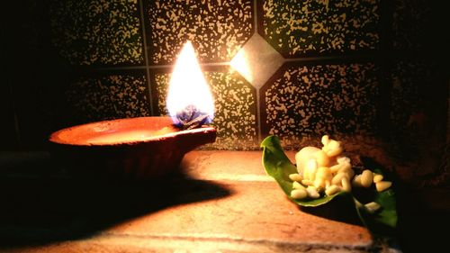 Close-up of lit candles on table