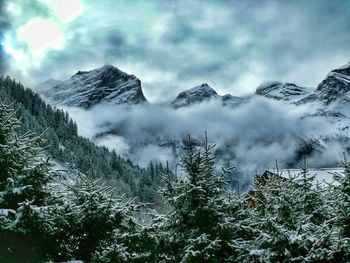 Scenic view of mountains against cloudy sky