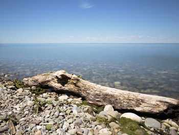 Rocks by sea against sky