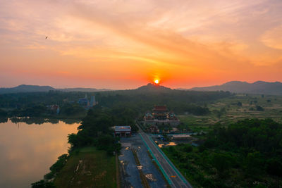 High angle view of road by mountains against orange sky