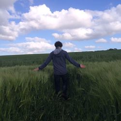 Rear view of man standing on field