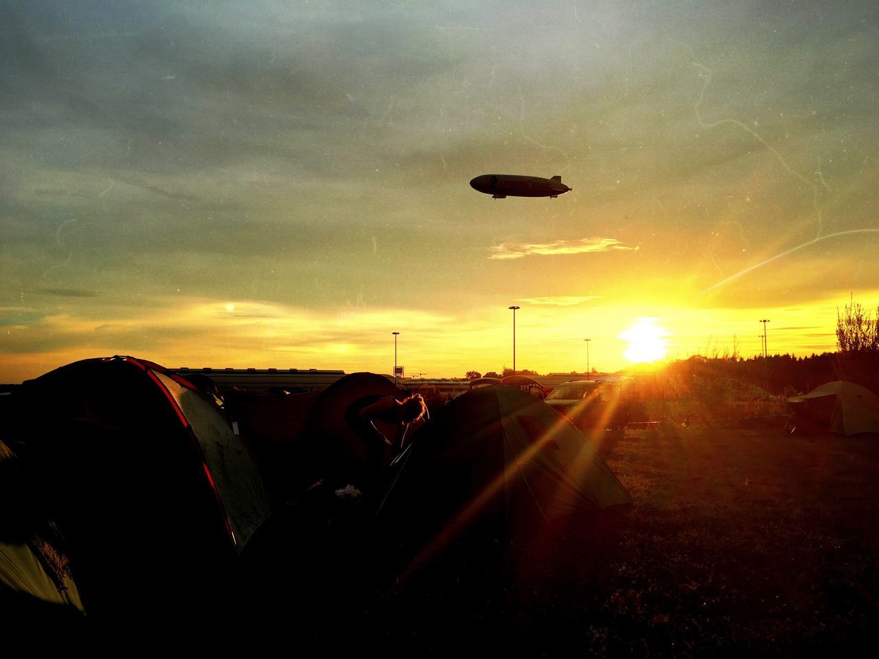 SILHOUETTE OF HOT AIR BALLOONS AGAINST SKY DURING SUNSET