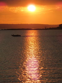 Scenic view of sea against orange sky