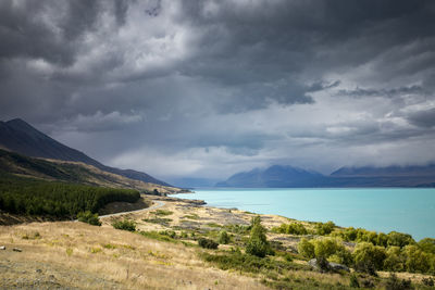 Scenic view of sea and mountains against sky