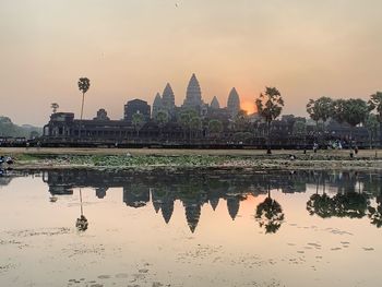 Reflection of building in water at sunset