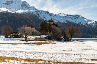 Silvaplana,switzerland, february 21, 2023 historic old castle crap da sass at the lake of silvaplana 