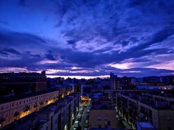 High angle view of illuminated buildings against sky at sunset