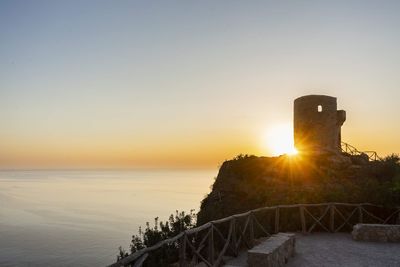 Scenic view of sea against clear sky during sunset