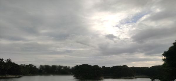 Scenic view of river against sky at sunset