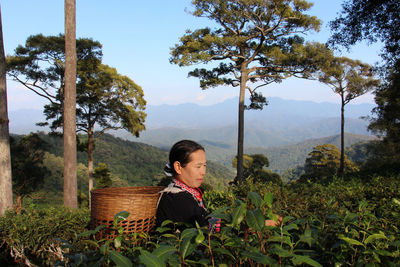 Woman on mountain against sky