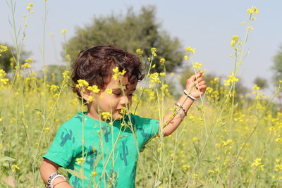 Portrait of boy standing on field