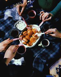Midsection of people holding drink