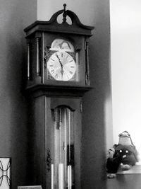 Statue of clock on wall