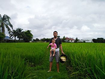 Full length portrait of man on field against sky
