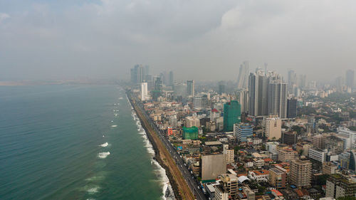 Aerial drone of streets and railway on the coast of the city of colombo. sri lanka.