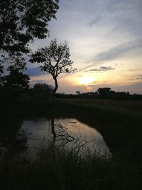 Scenic view of lake against sky during sunset