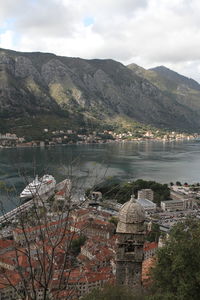 Scenic view of lake by buildings against sky