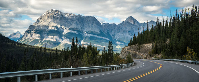 Panoramic view of road by mountains against sky