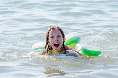 Funny expression on a swimming girl in lake michigan  usa