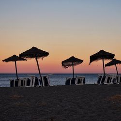 People at beach during sunset