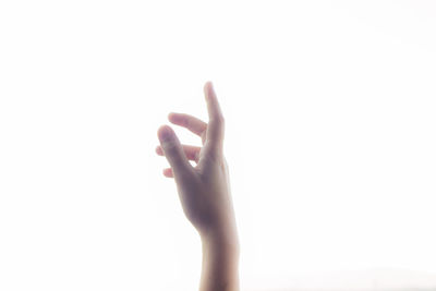 Close-up of woman hand over white background