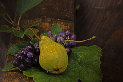 High angle view of pear with grapes on table