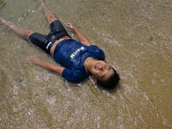 High angle portrait of man lying down on land