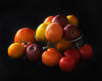 Close-up of apples on table against black background
