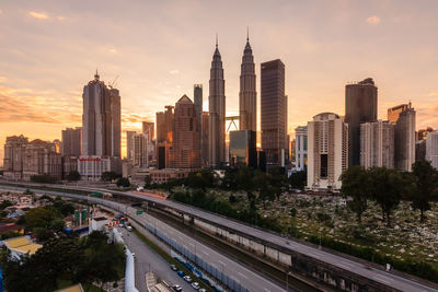 Panoramic view of city buildings against sky during sunset