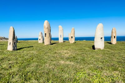 Scenic view of beach against clear blue sky