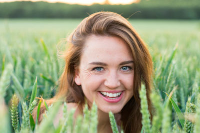 Portrait of a smiling young woman in field