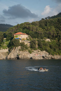 Scenic view of sea by buildings against sky