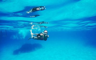 Young woman swimming in water