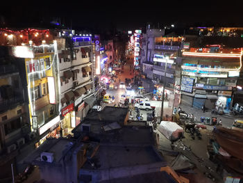 High angle view of illuminated street amidst buildings in city