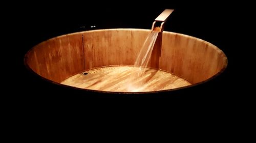 Close-up of cake on table against black background
