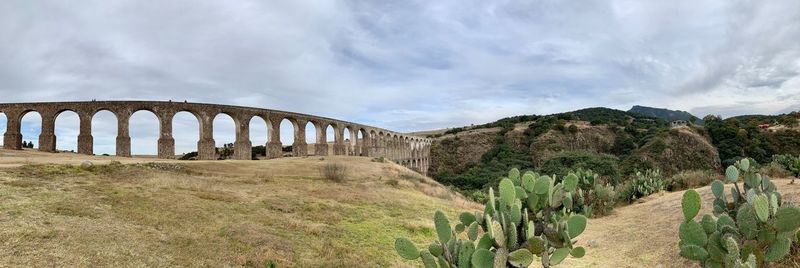 Panoramic shot of bridge over land against sky