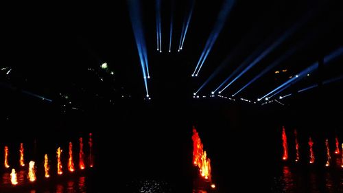 Low angle view of illuminated lights at night